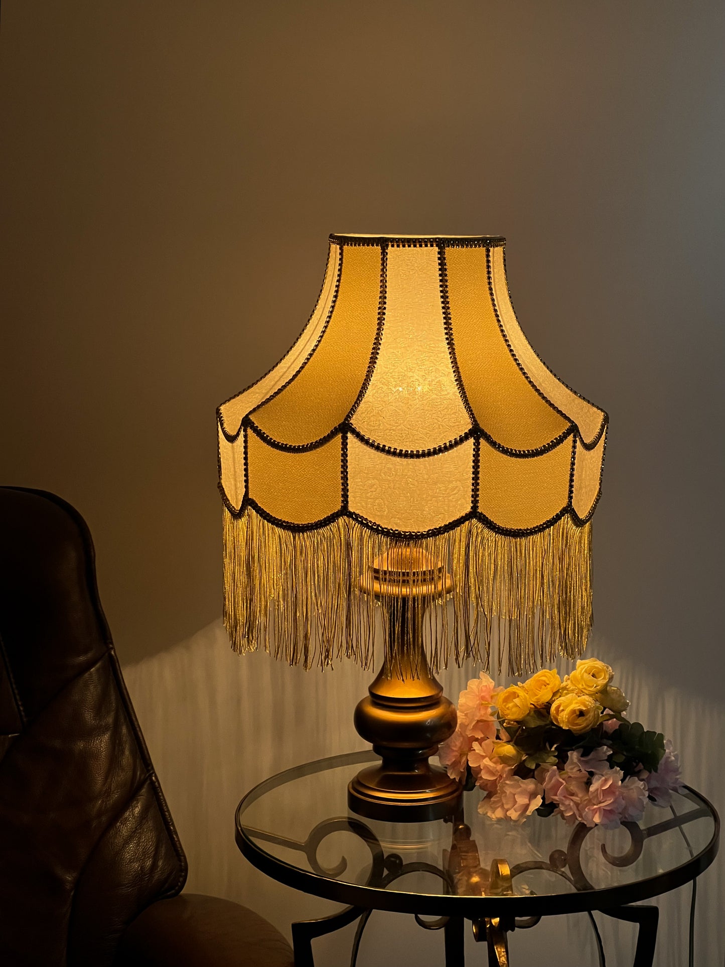 Gold-colored table lamp with elegant lace details and tasseled fringe. 7202