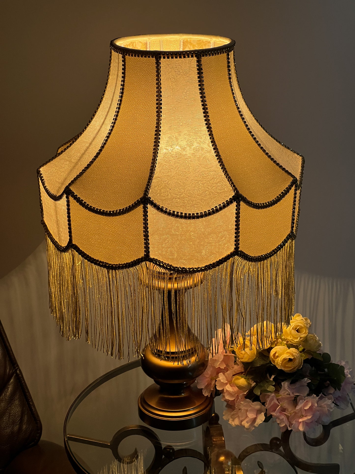 Gold-colored table lamp with elegant lace details and tasseled fringe. 7202