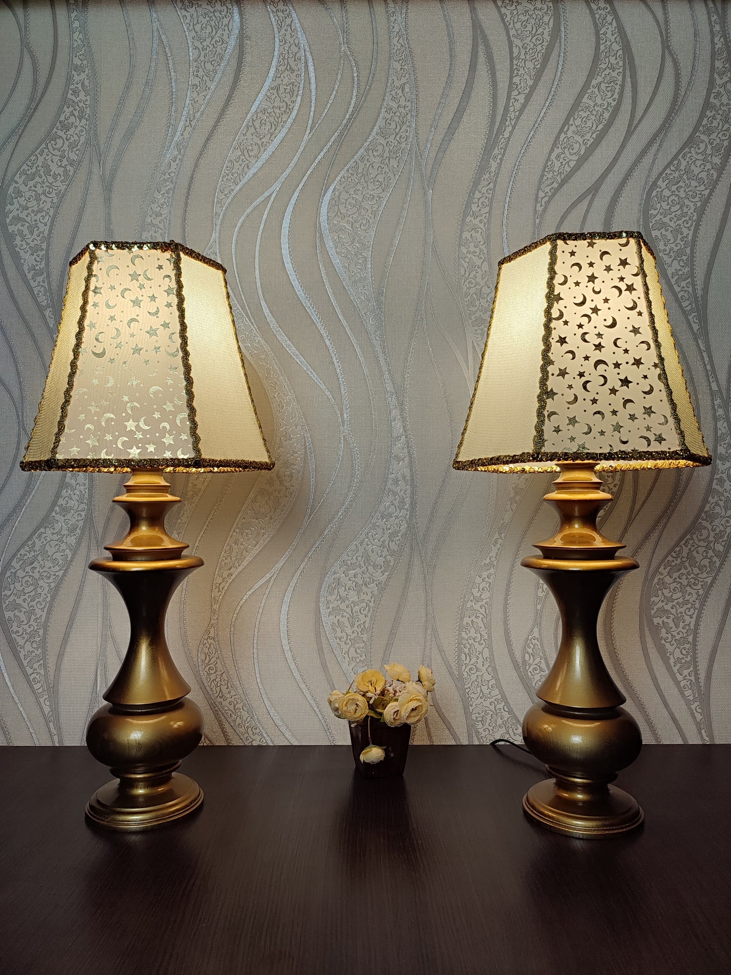 Table lamp. Golden celestial lamp with shimmering moons and stars on a delicate fabric. The wooden base is bronze in color. 7701