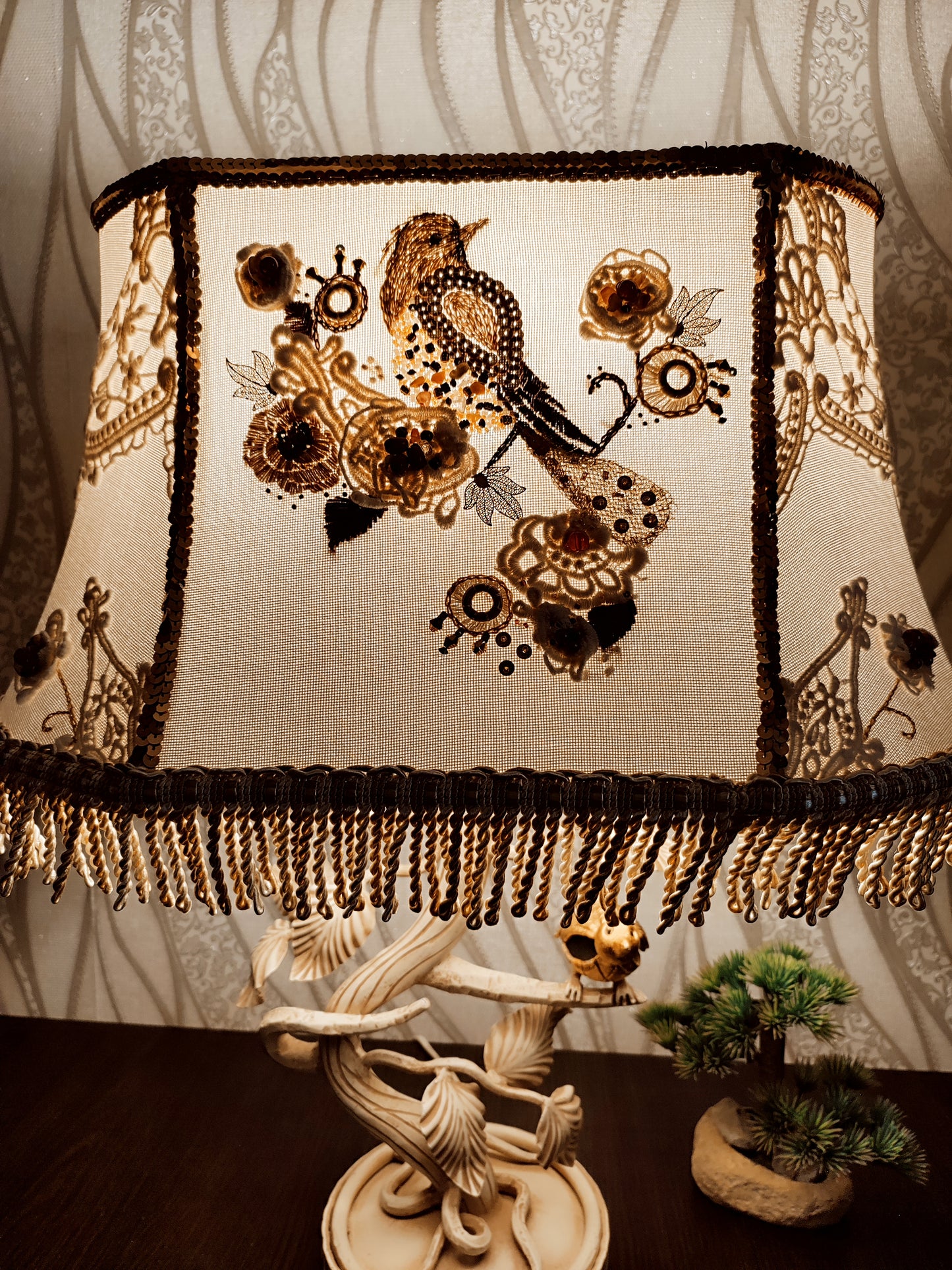 Lampshade. A unique lampshade with an embroidered bird and crocheted flowers.