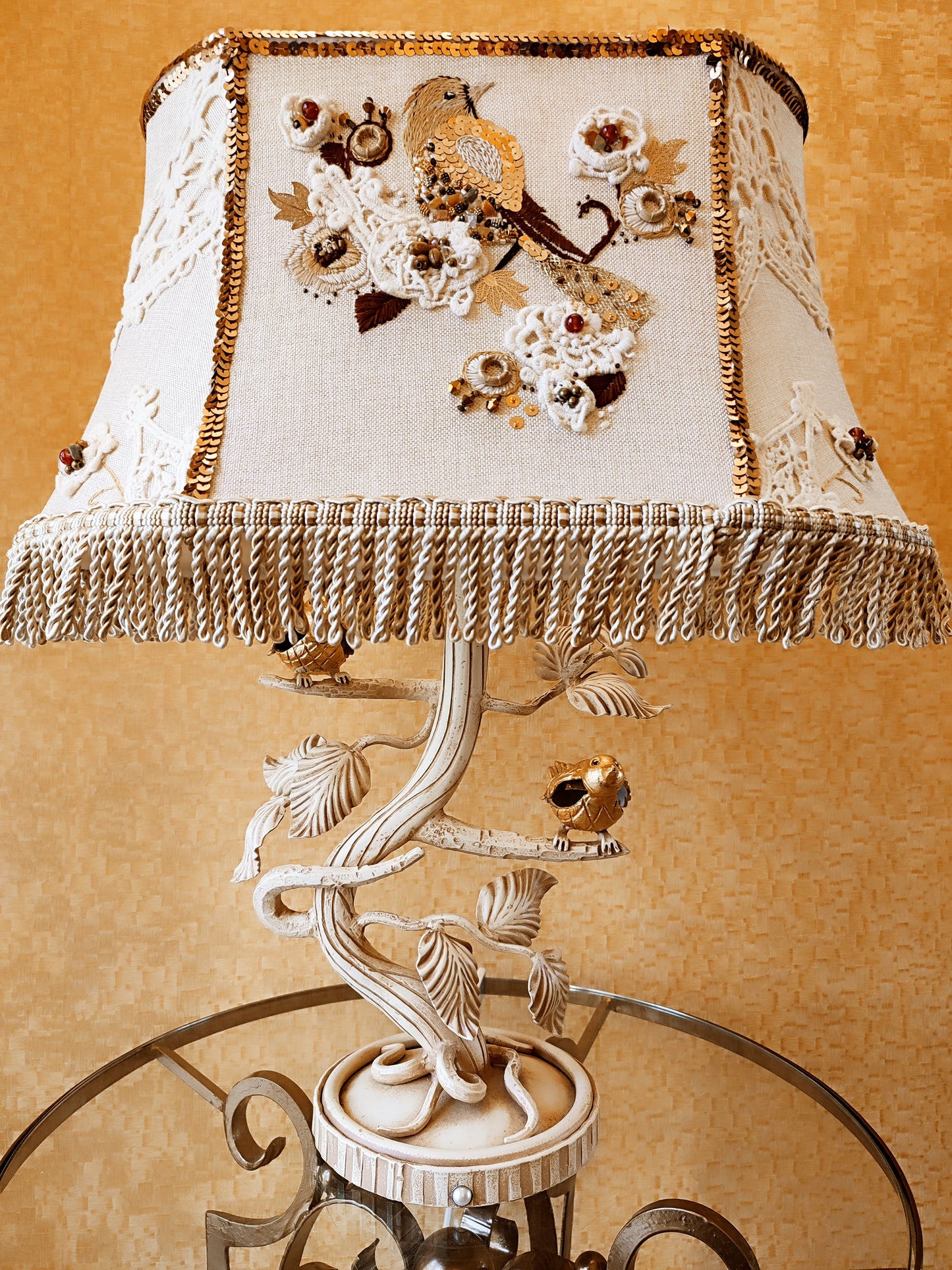 Lampshade. A unique lampshade with an embroidered bird and crocheted flowers.