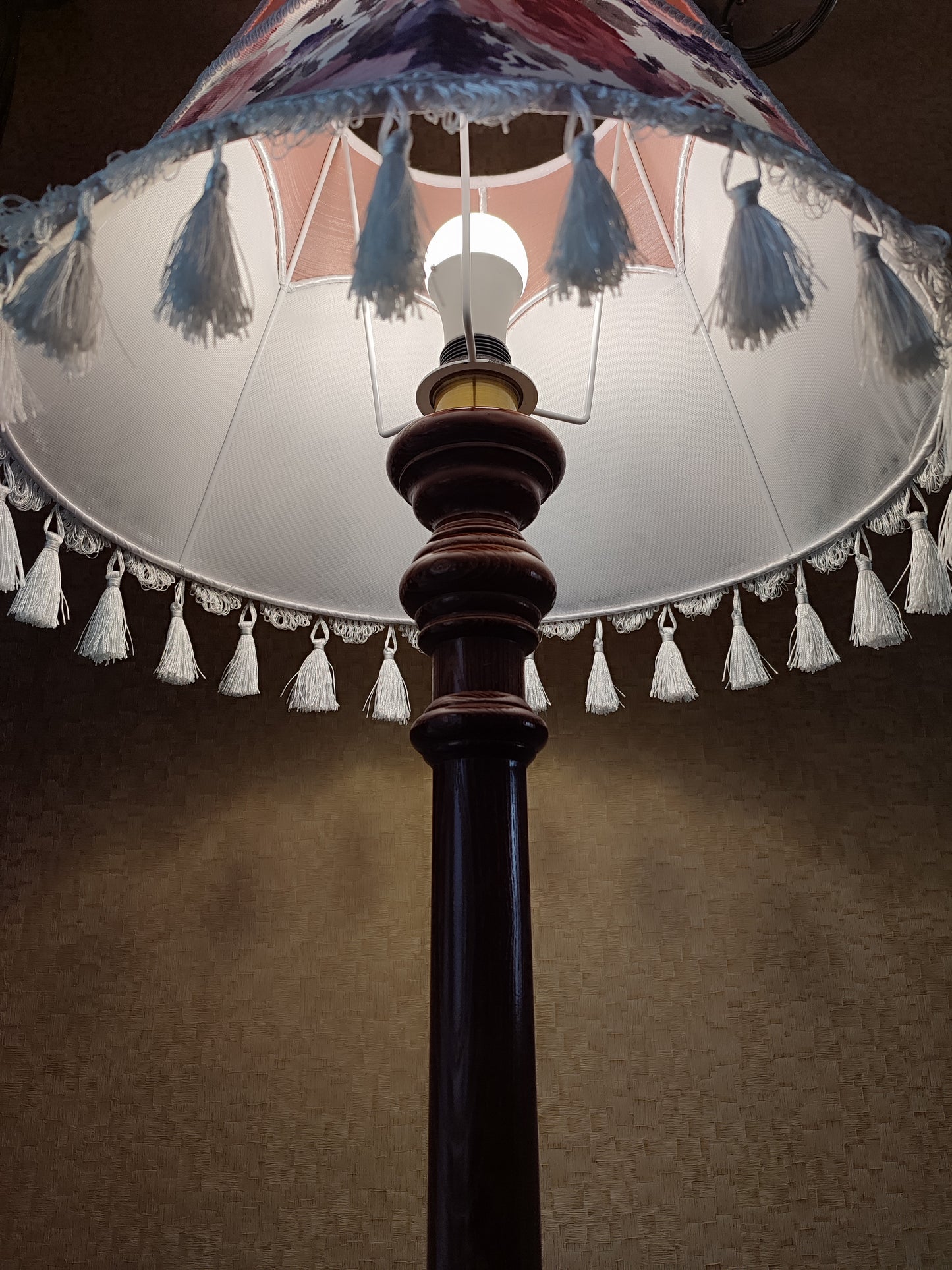Floor lamp, pastel pink top, blooming flower shade, delicate fringe with tassels, on an elegant wooden base. 3601