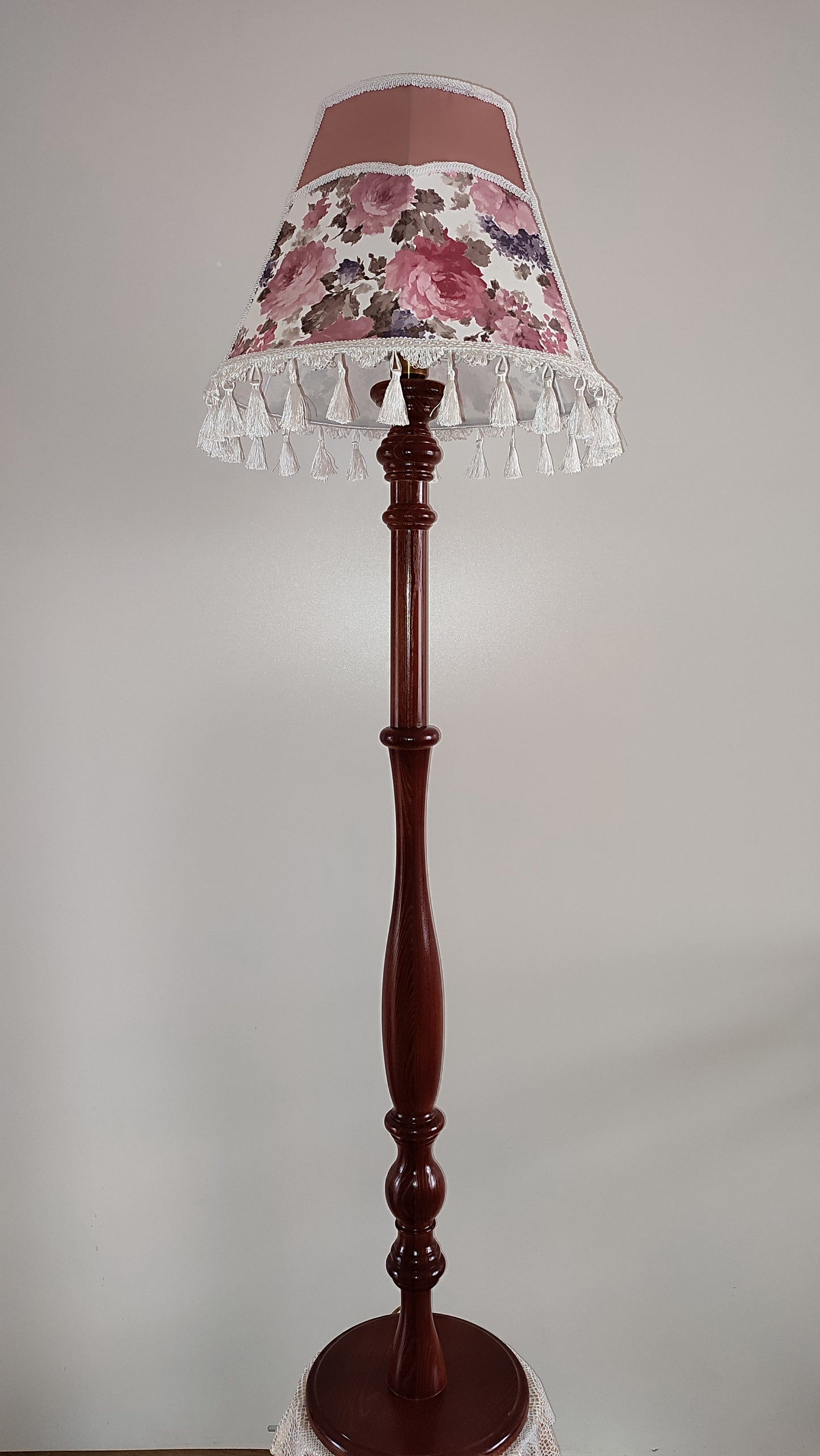 Floor lamp, pastel pink top, blooming flower shade, delicate fringe with tassels, on an elegant wooden base. 3601