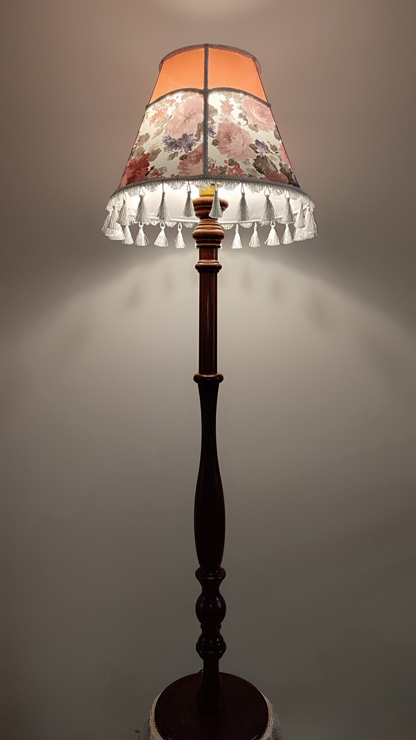 Floor lamp, pastel pink top, blooming flower shade, delicate fringe with tassels, on an elegant wooden base. 3601