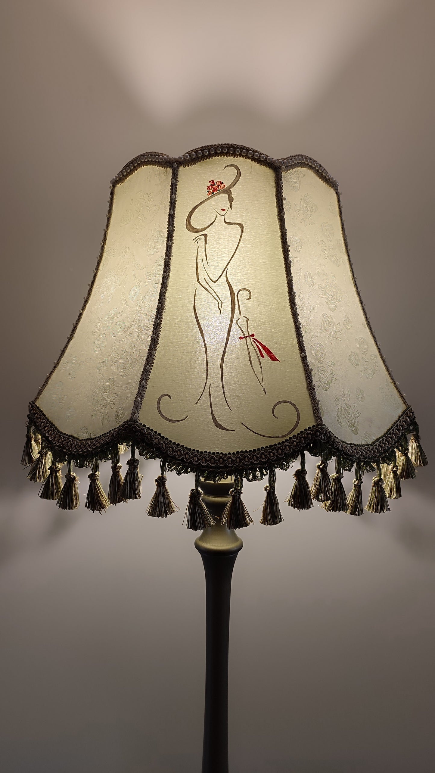 A Victorian floor lamp with a fabric shade and an exquisite floral umbrella motif with tassels. 3705