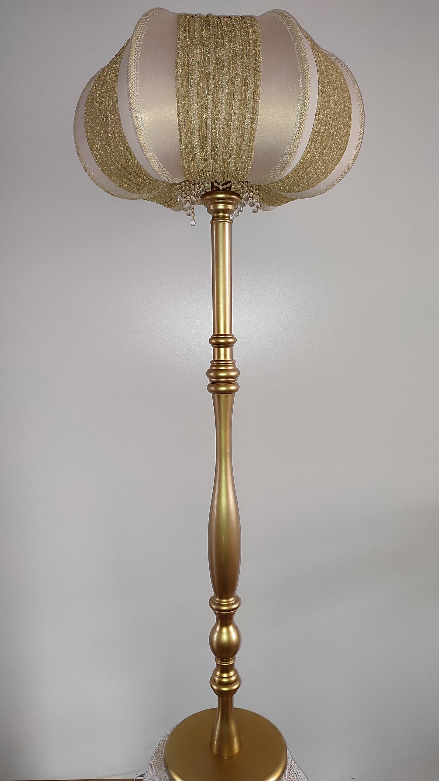 A two-tone creamy golden lampshade, delicate crystal beads and an elegant wooden base add a touch of luxurious radiance 2206