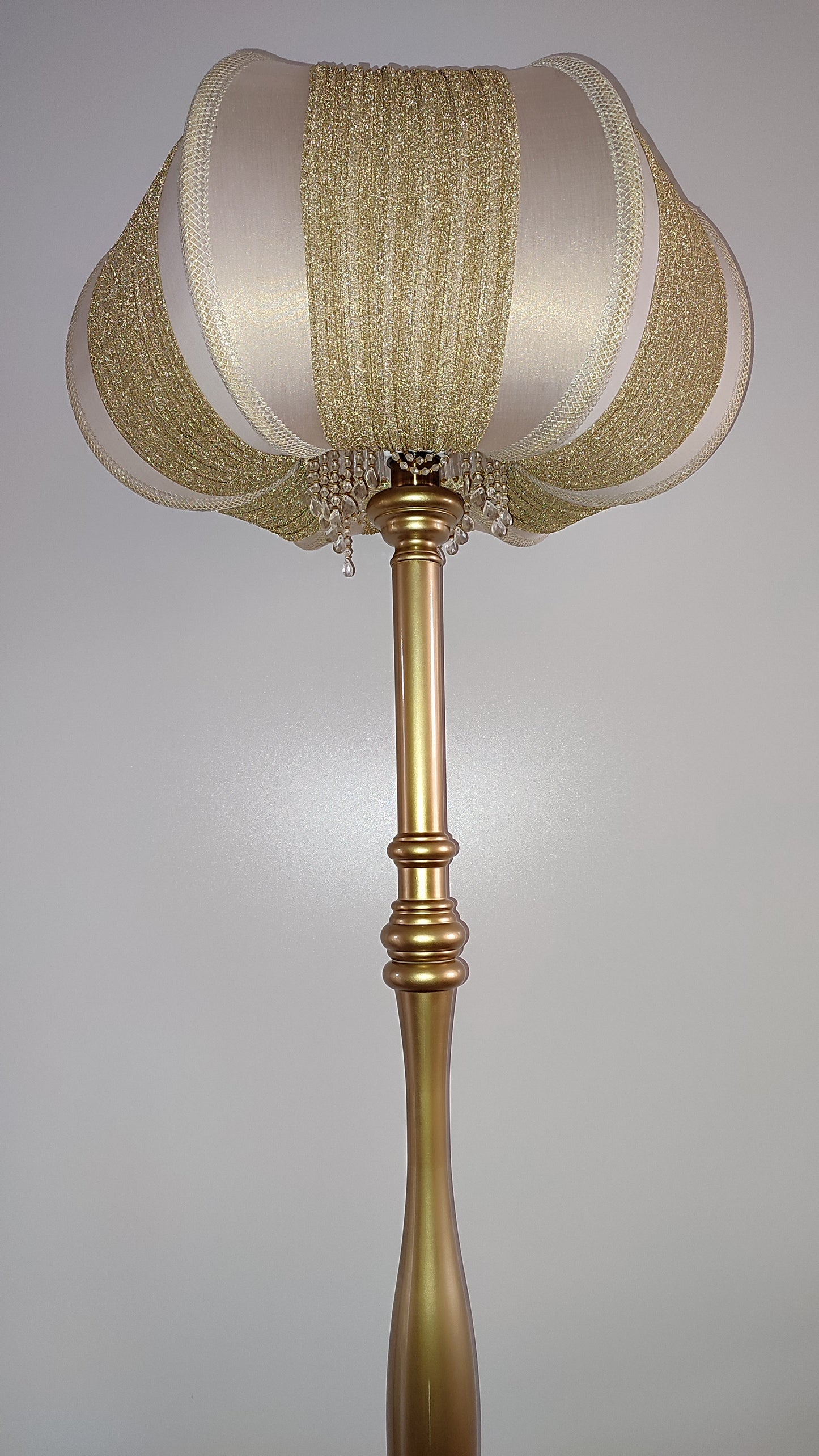 A two-tone creamy golden lampshade, delicate crystal beads and an elegant wooden base add a touch of luxurious radiance 2206