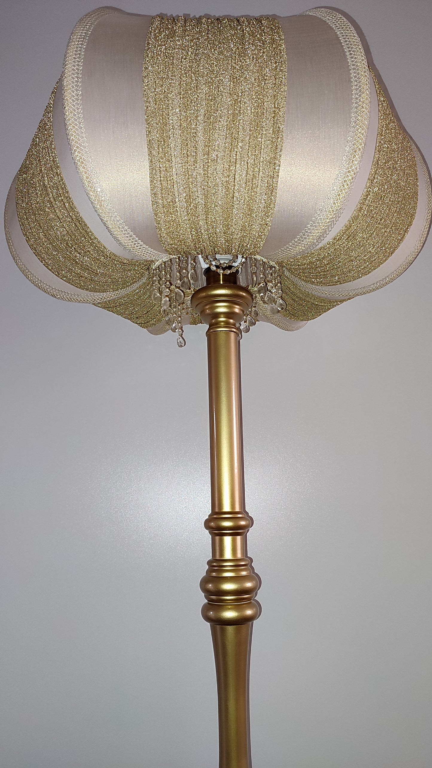 A two-tone creamy golden lampshade, delicate crystal beads and an elegant wooden base add a touch of luxurious radiance 2206