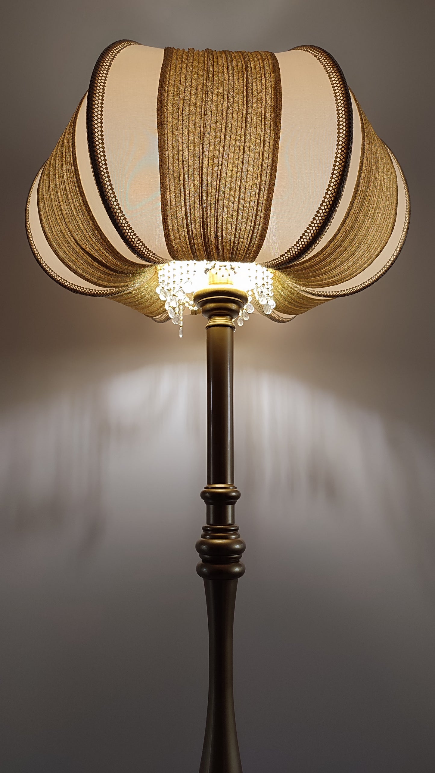 A two-tone creamy golden lampshade, delicate crystal beads and an elegant wooden base add a touch of luxurious radiance 2206
