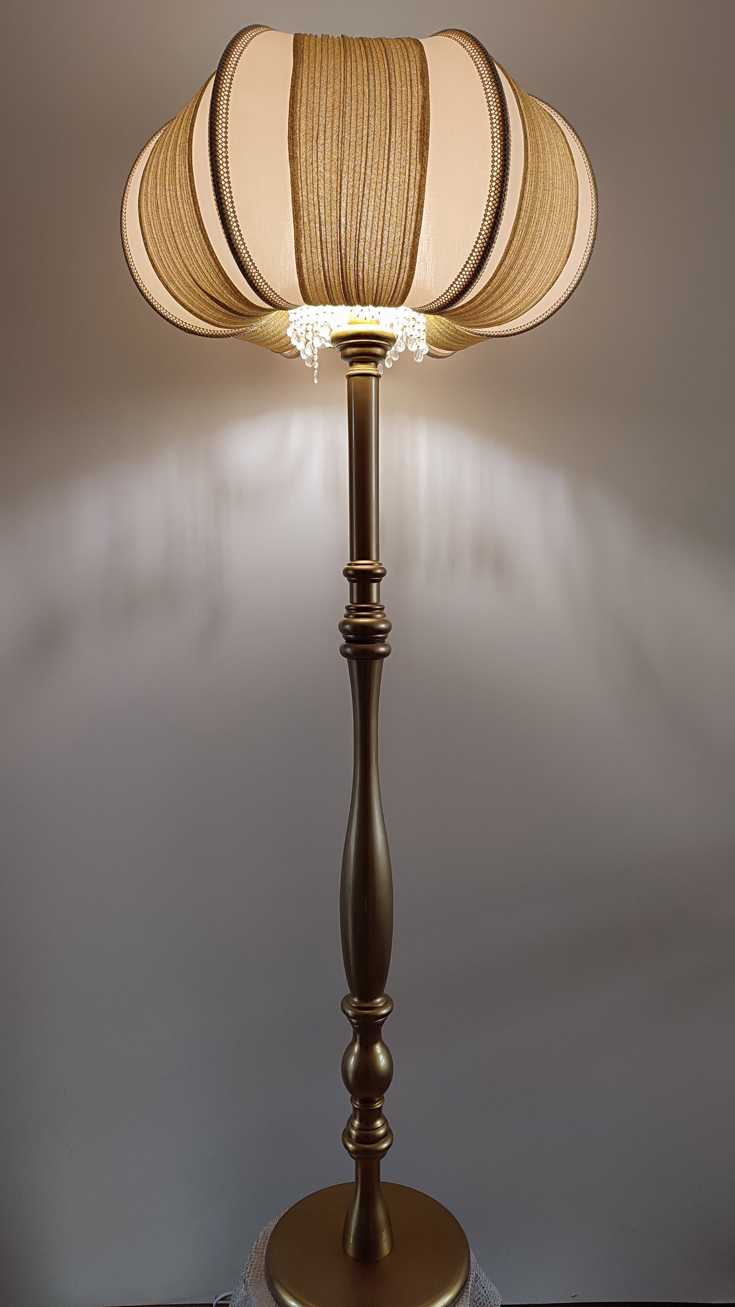 A two-tone creamy golden lampshade, delicate crystal beads and an elegant wooden base add a touch of luxurious radiance 2206