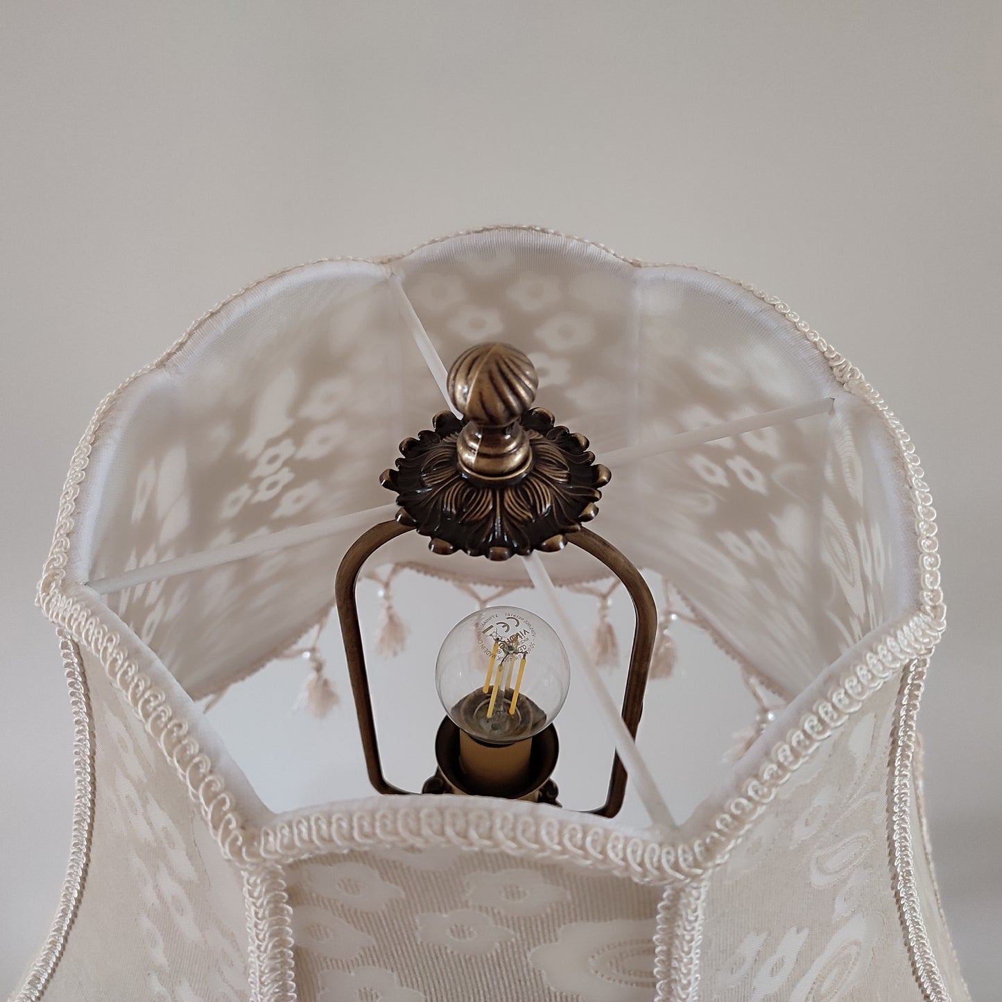Handmade beige lampshade with beads and fringe featuring a floral pattern. № 2002