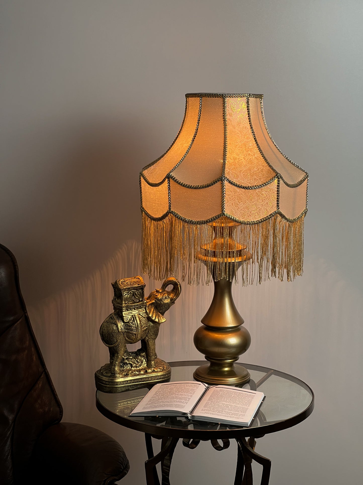 Gold-colored table lamp with elegant lace details and tasseled fringe. 7202