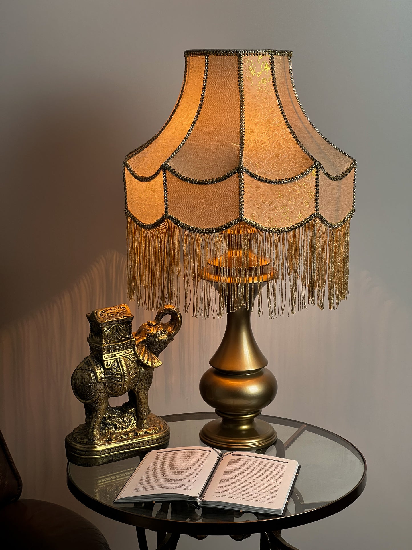Gold-colored table lamp with elegant lace details and tasseled fringe. 7202