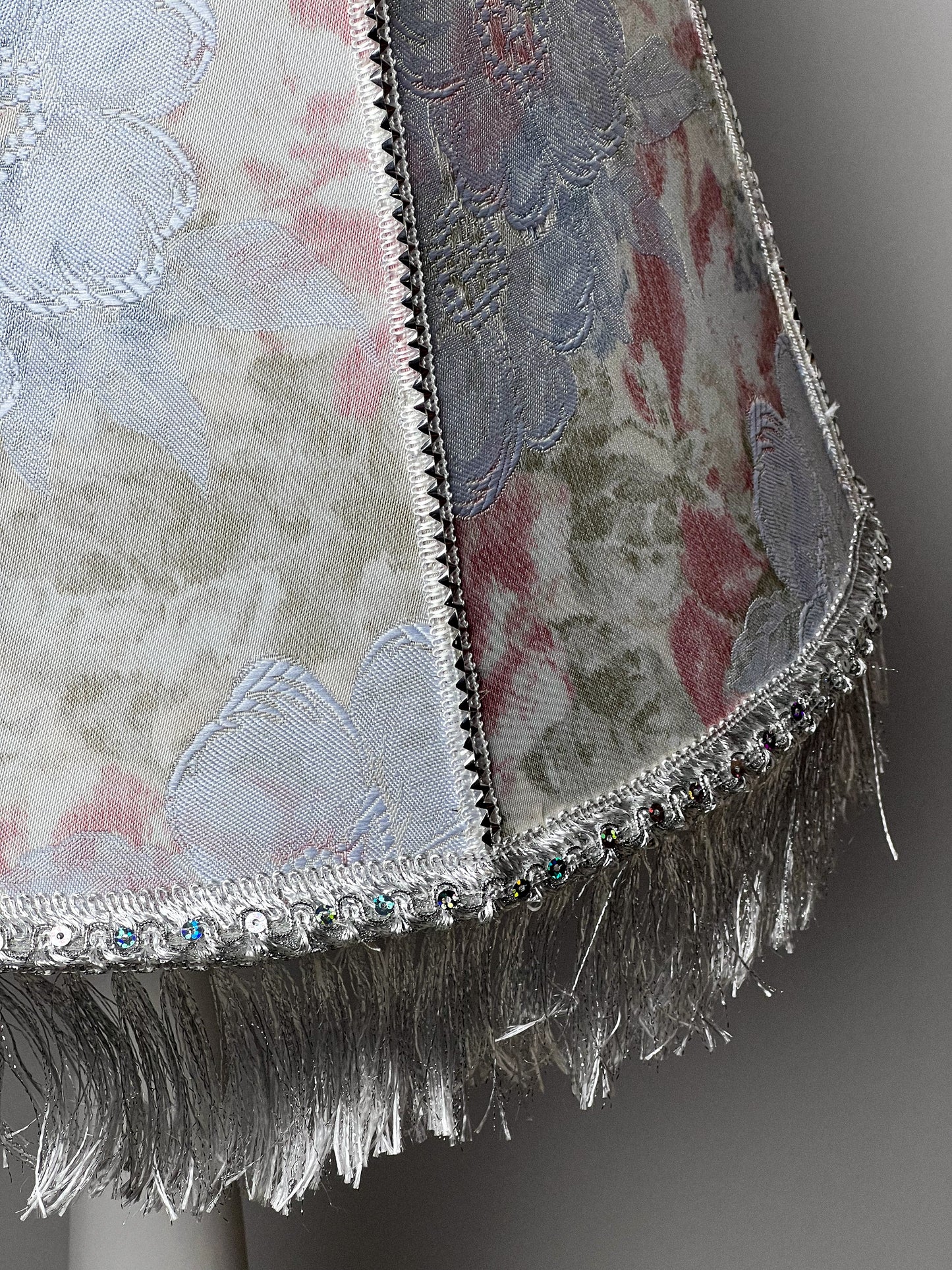 Floral lampshade with embossed patterned fabric and fringe. 0203