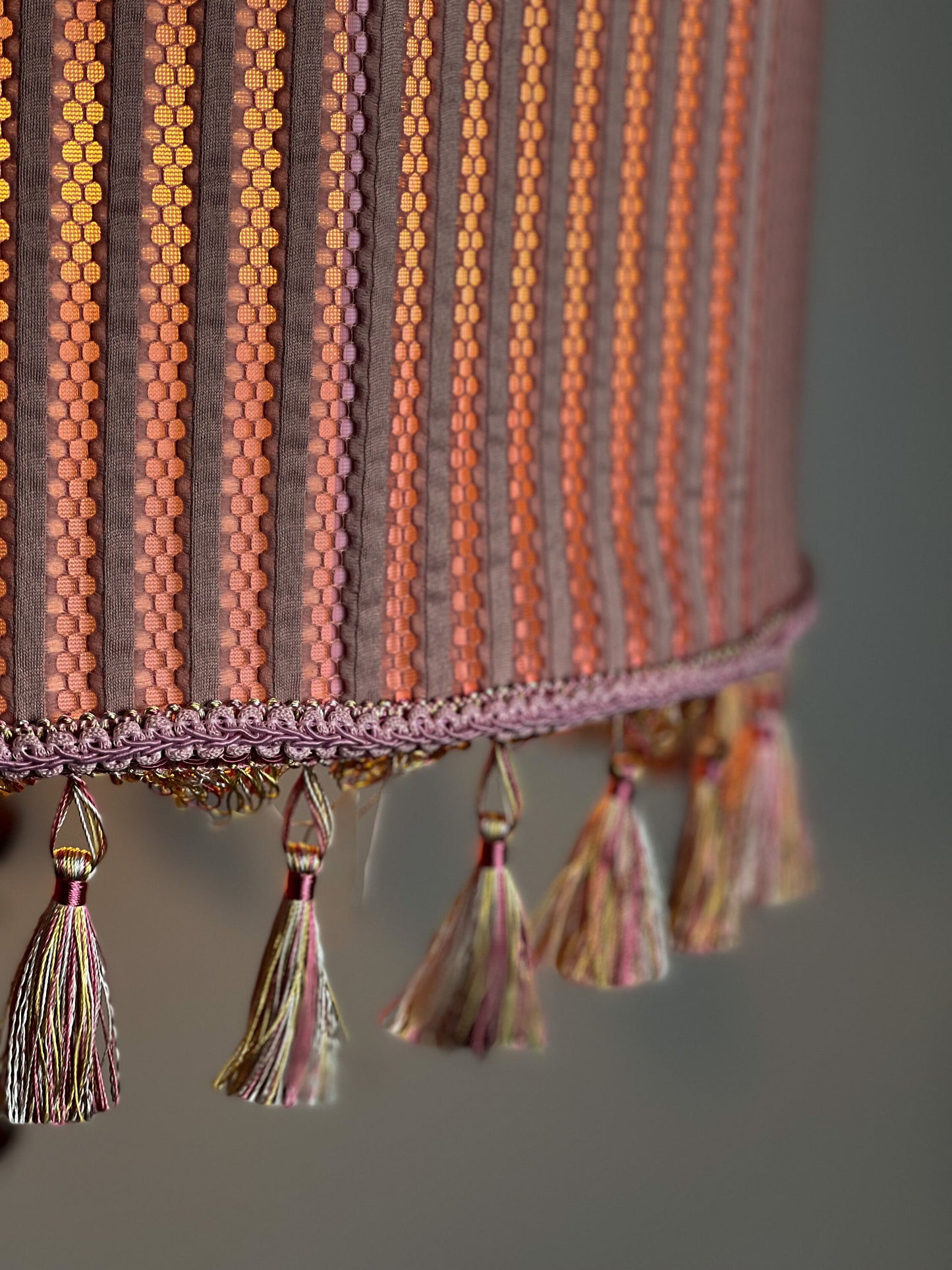 Pink fabric lampshade with embossed surface.