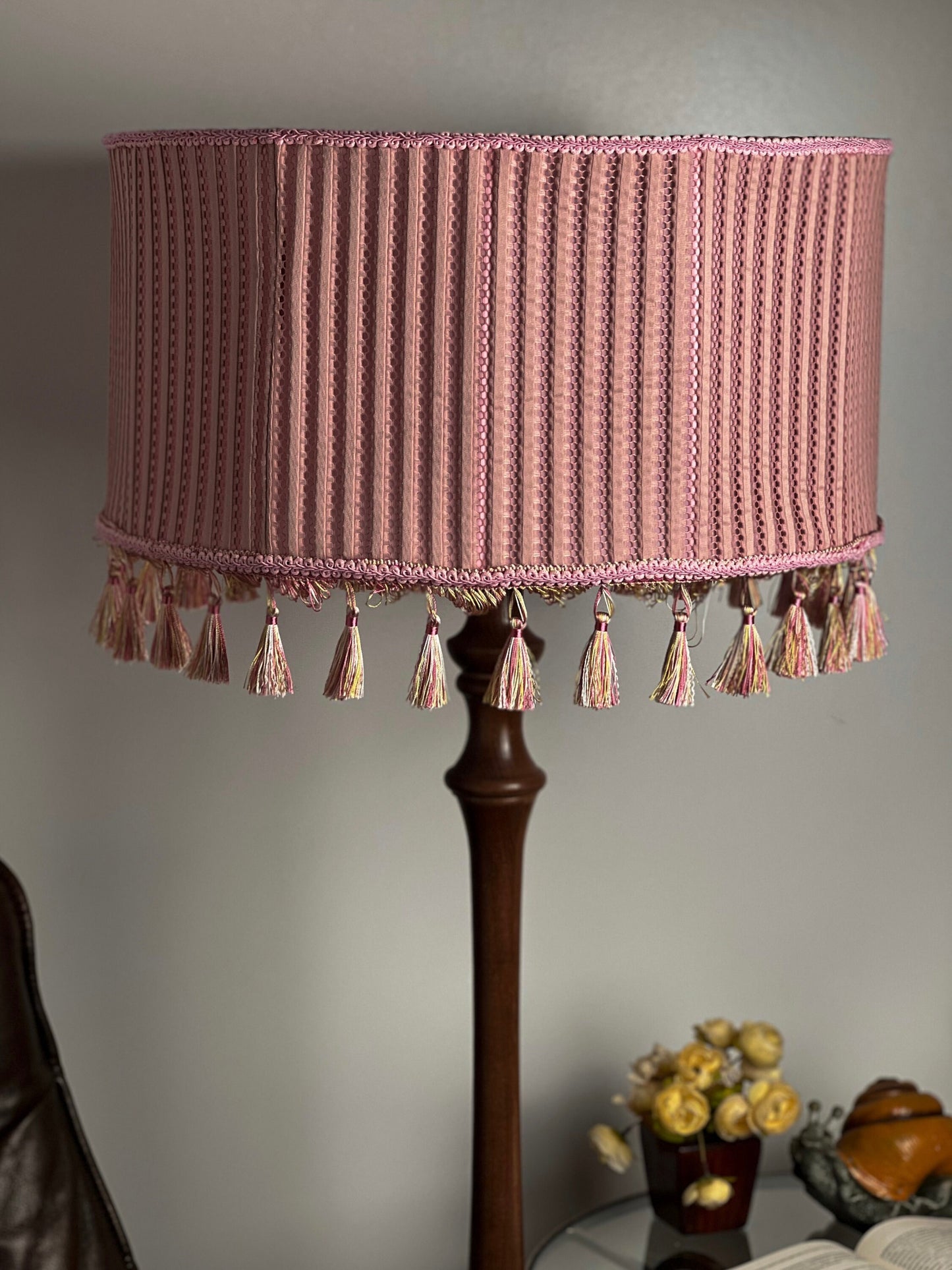 Pink fabric lampshade with embossed surface.