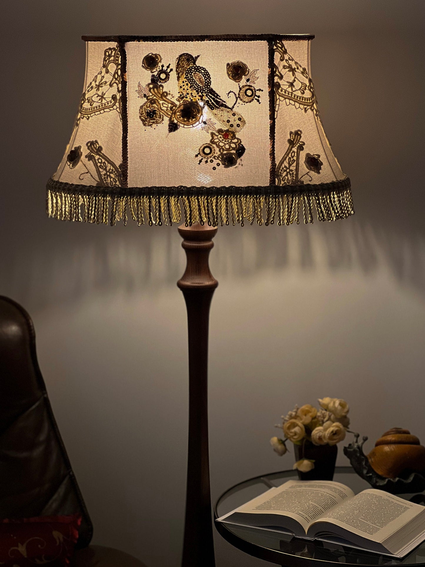 Lampshade. A unique lampshade with an embroidered bird and crocheted flowers.