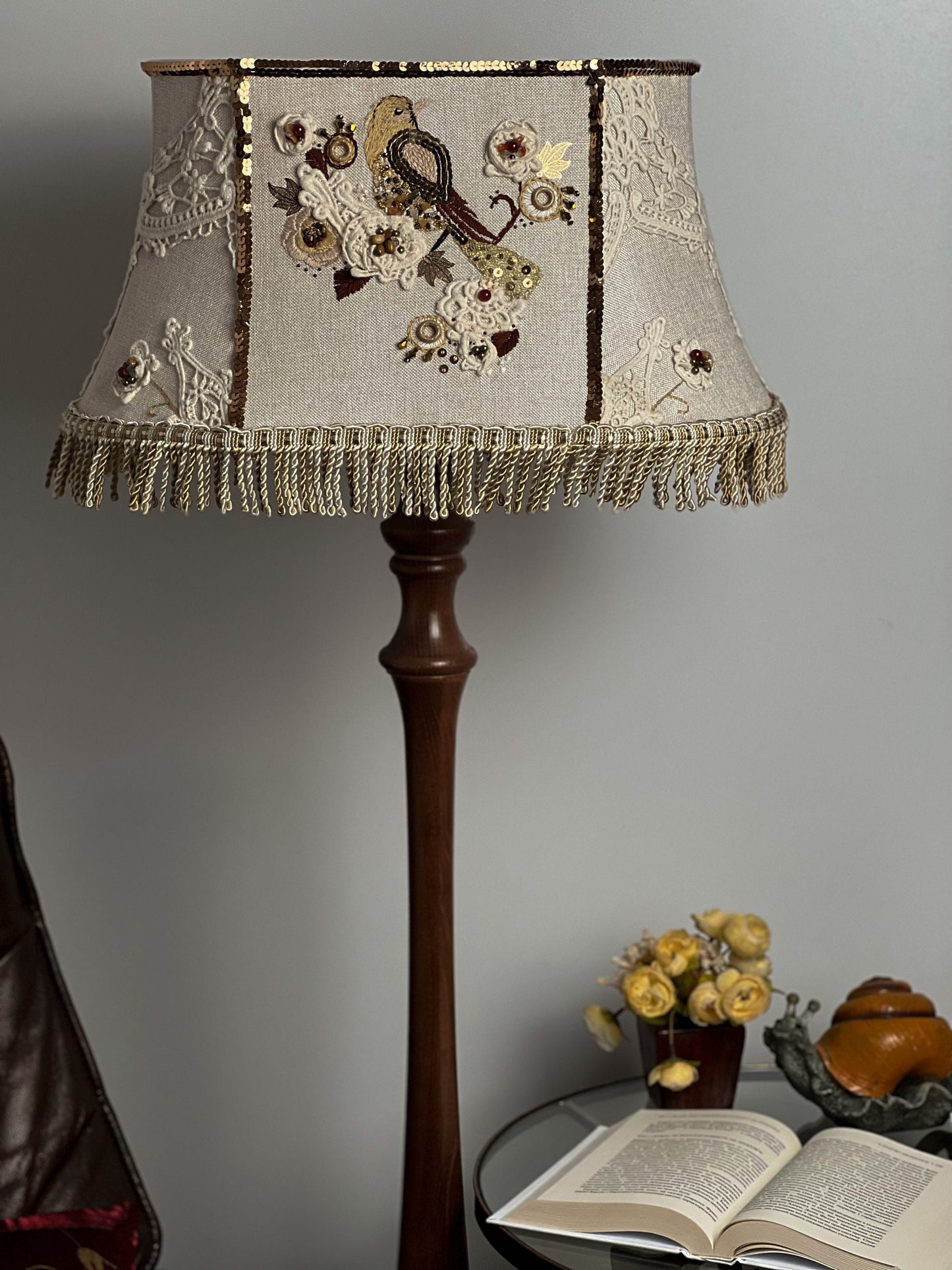 Lampshade. A unique lampshade with an embroidered bird and crocheted flowers.