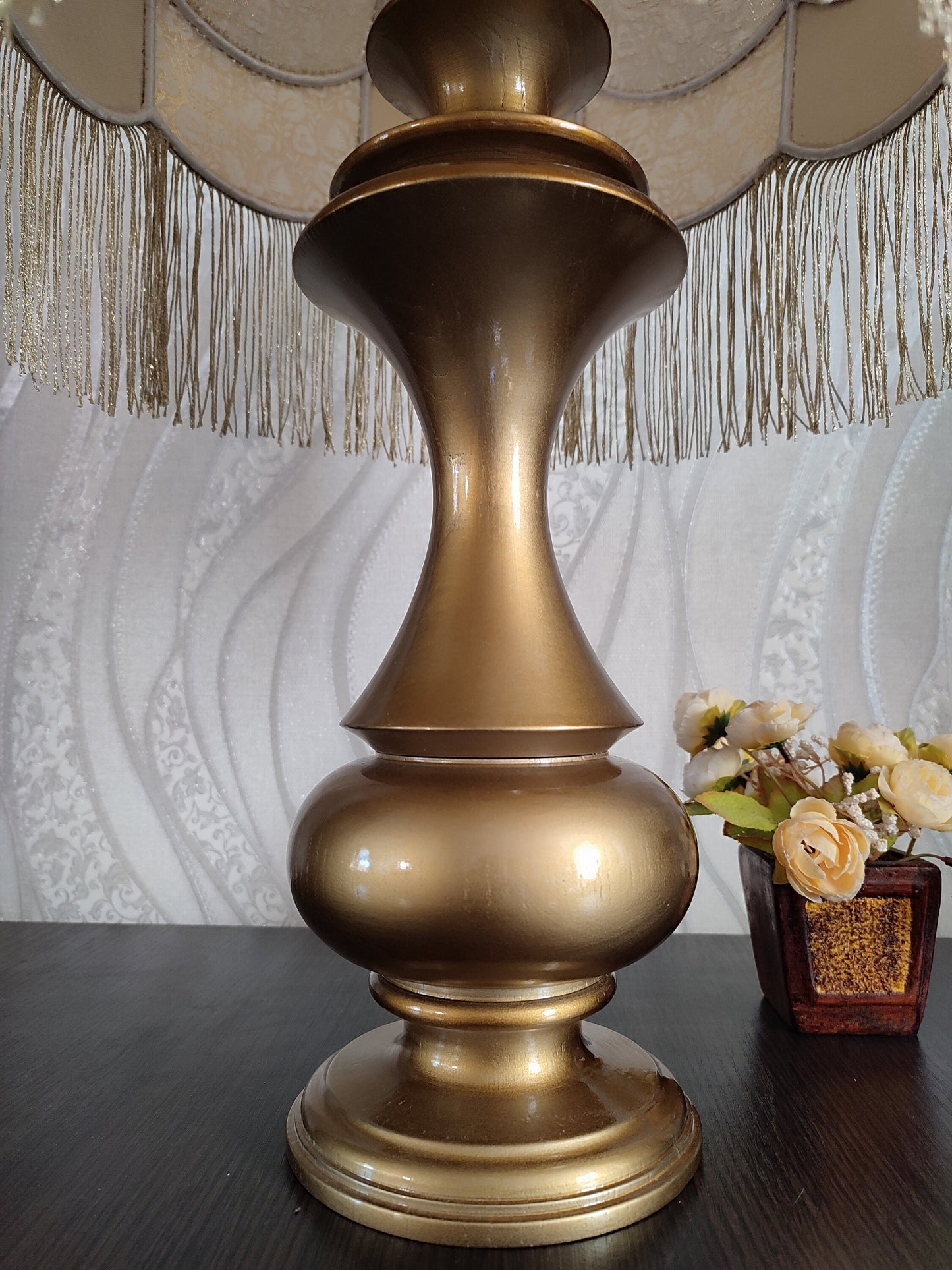 Gold-colored table lamp with elegant lace details and tasseled fringe. 7202