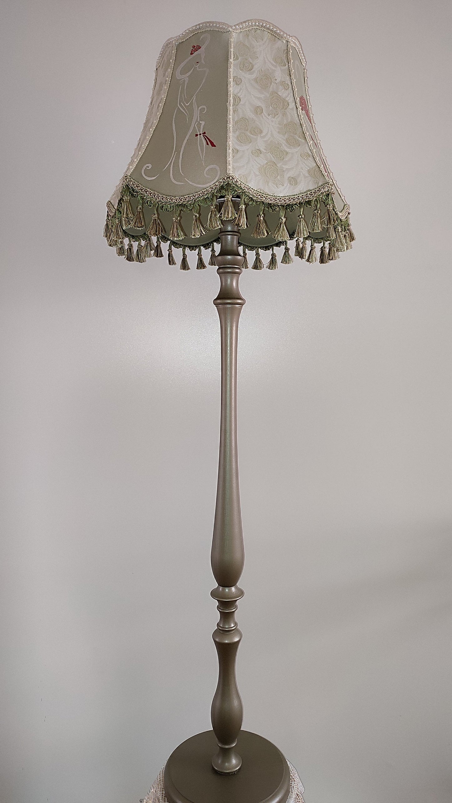 A Victorian floor lamp with a fabric shade and an exquisite floral umbrella motif with tassels. 3705