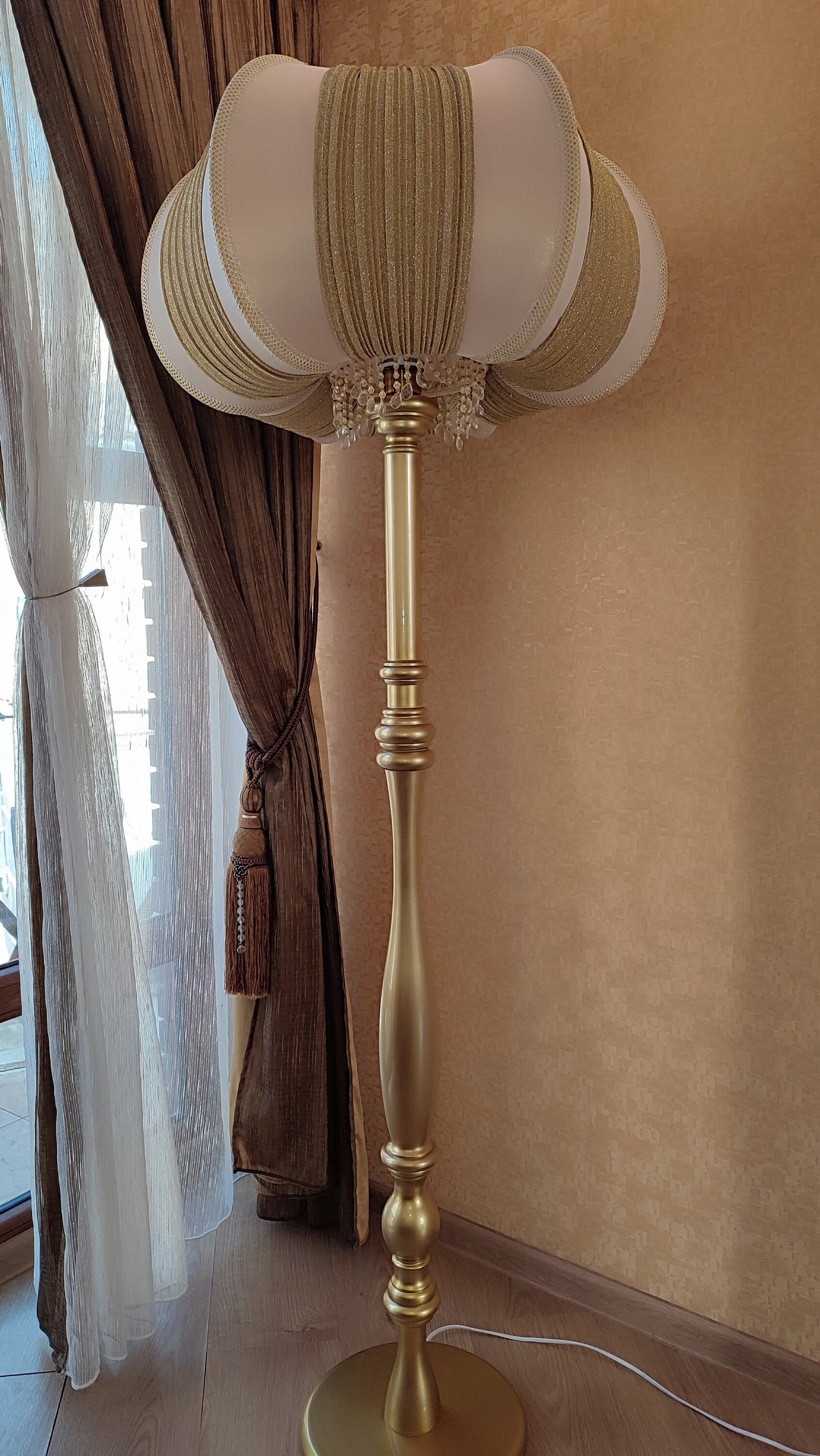 A two-tone creamy golden lampshade, delicate crystal beads and an elegant wooden base add a touch of luxurious radiance 2206