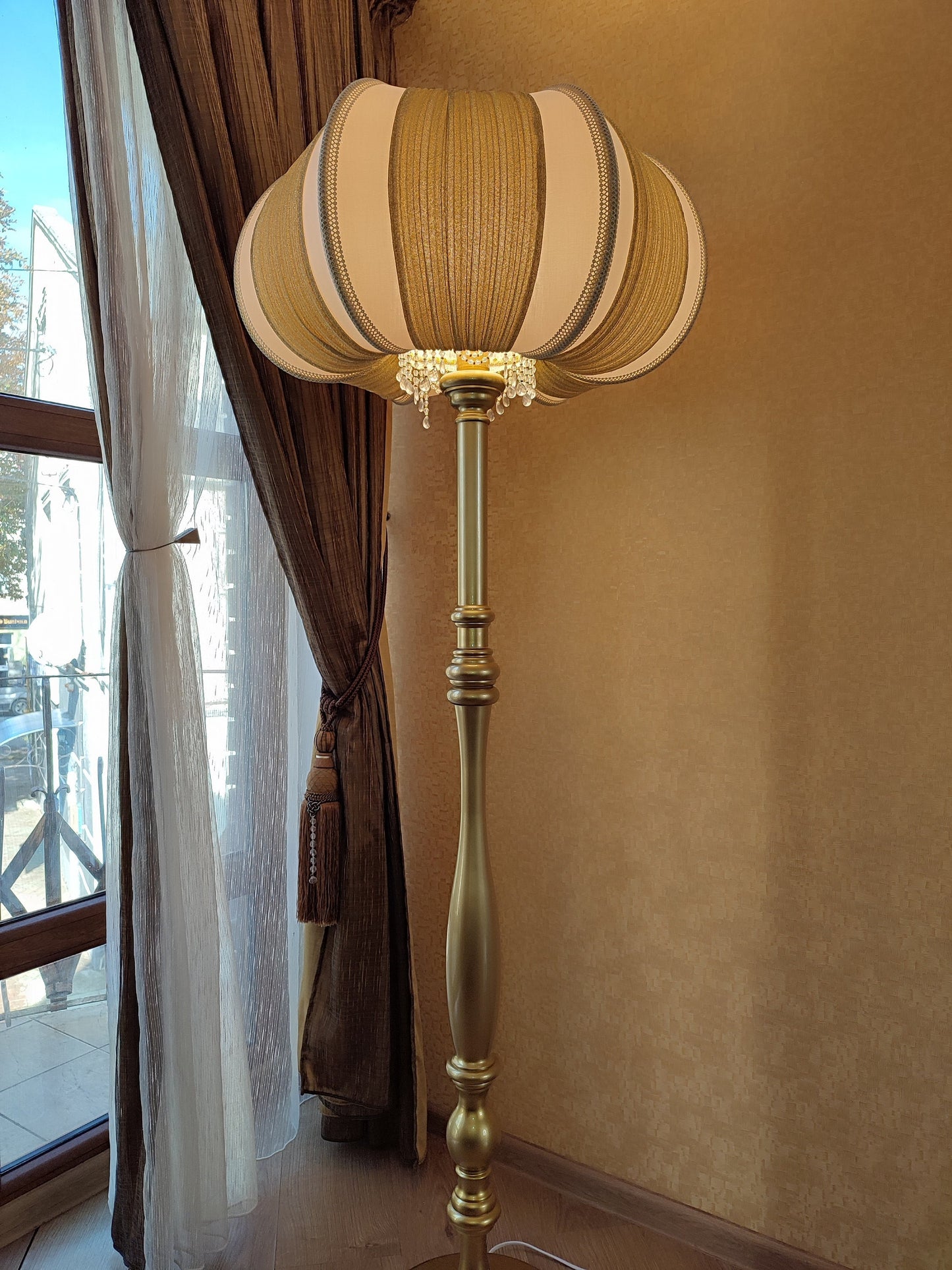 A two-tone creamy golden lampshade, delicate crystal beads and an elegant wooden base add a touch of luxurious radiance 2206