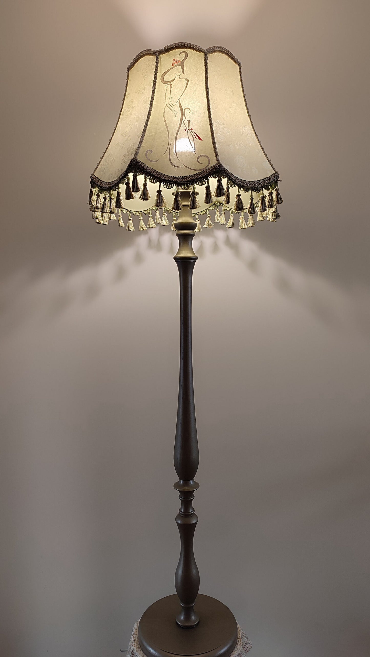 A Victorian floor lamp with a fabric shade and an exquisite floral umbrella motif with tassels. 3705