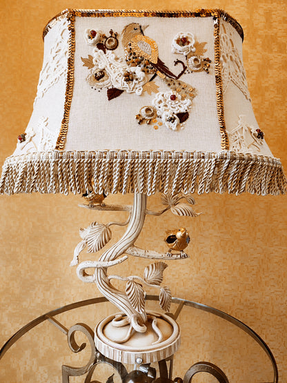 Lampshade. A unique lampshade with an embroidered bird and crocheted flowers.