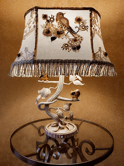 Lampshade. A unique lampshade with an embroidered bird and crocheted flowers.