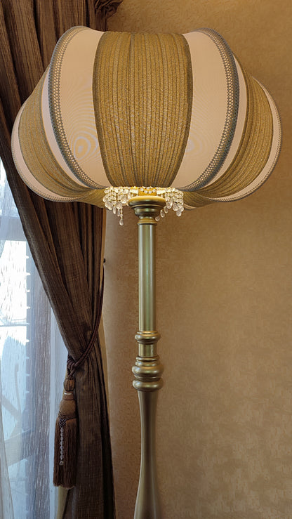 A two-tone creamy golden lampshade, delicate crystal beads and an elegant wooden base add a touch of luxurious radiance 2206