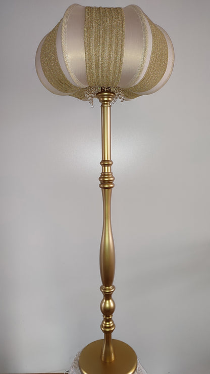 A two-tone creamy golden lampshade, delicate crystal beads and an elegant wooden base add a touch of luxurious radiance 2206