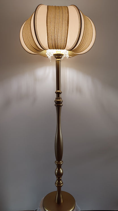 A two-tone creamy golden lampshade, delicate crystal beads and an elegant wooden base add a touch of luxurious radiance 2206