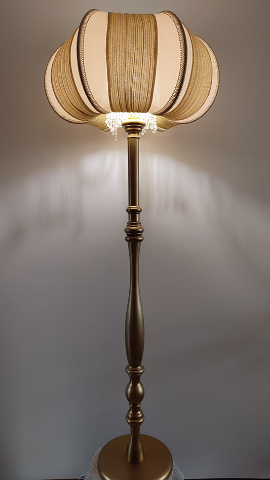 A two-tone creamy golden lampshade, delicate crystal beads and an elegant wooden base add a touch of luxurious radiance 2206