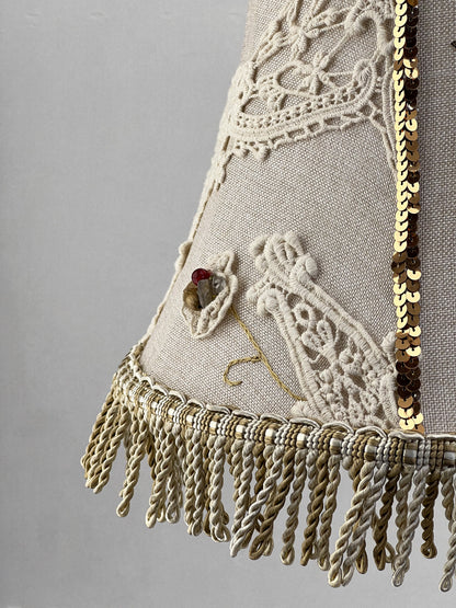 Lampshade. A unique lampshade with an embroidered bird and crocheted flowers.