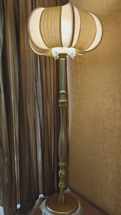 A two-tone creamy golden lampshade, delicate crystal beads and an elegant wooden base add a touch of luxurious radiance 2206