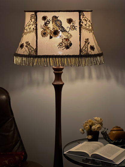 Lampshade. A unique lampshade with an embroidered bird and crocheted flowers.