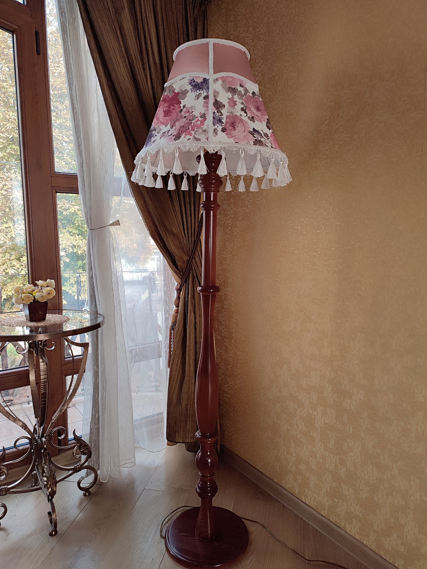 Floor lamp, pastel pink top, blooming flower shade, delicate fringe with tassels, on an elegant wooden base. 3601