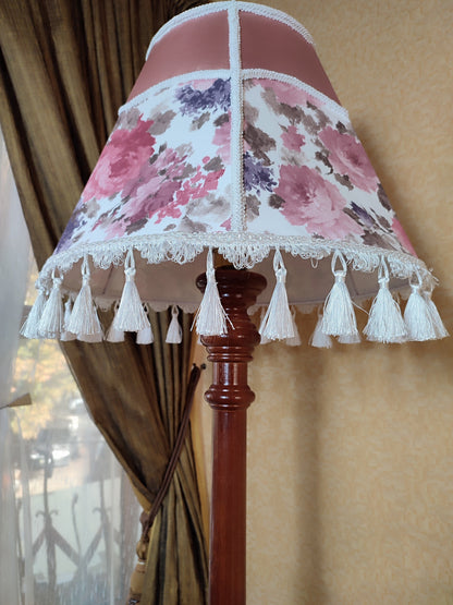 Floor lamp, pastel pink top, blooming flower shade, delicate fringe with tassels, on an elegant wooden base. 3601