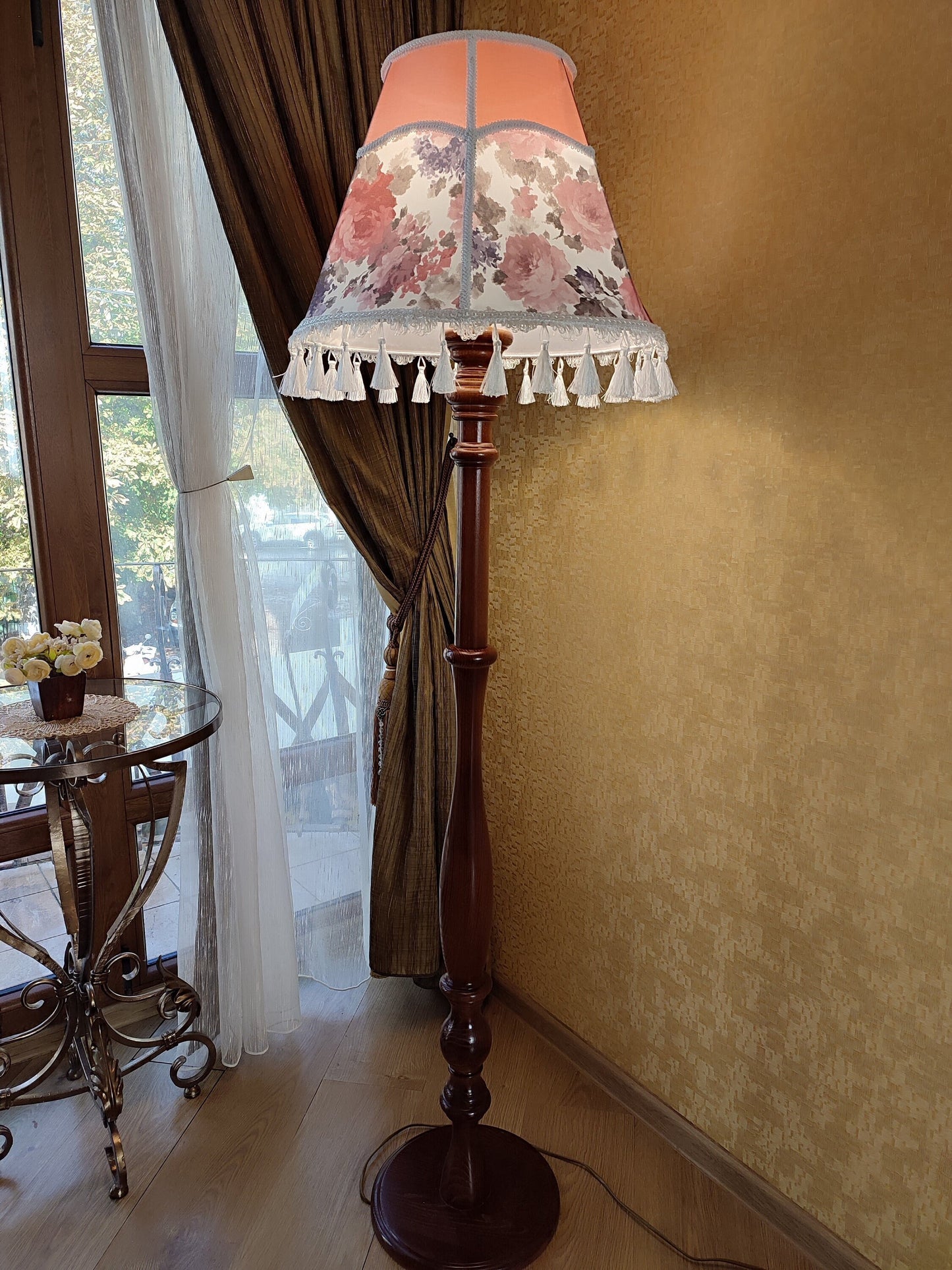 Floor lamp, pastel pink top, blooming flower shade, delicate fringe with tassels, on an elegant wooden base. 3601