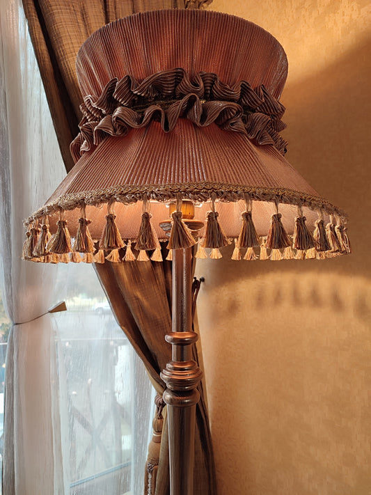 Floor lamp, Bronze elegance: Vintage golden hue, exquisite tasseled trim, elegant wooden base with artful accents.