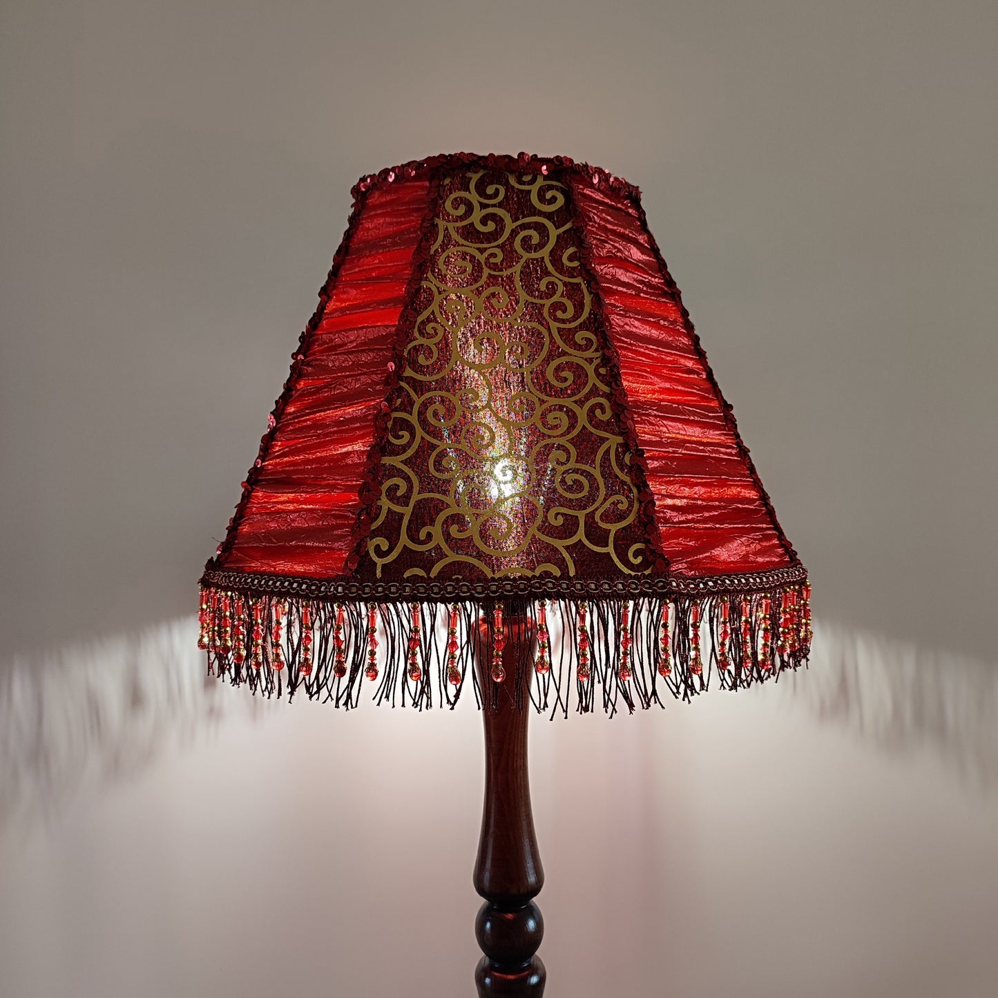 A burgundy lampshade with a swirling pattern and beaded fringe.Unique lamp, handcrafted laтббmp, decorative lamp. 1116