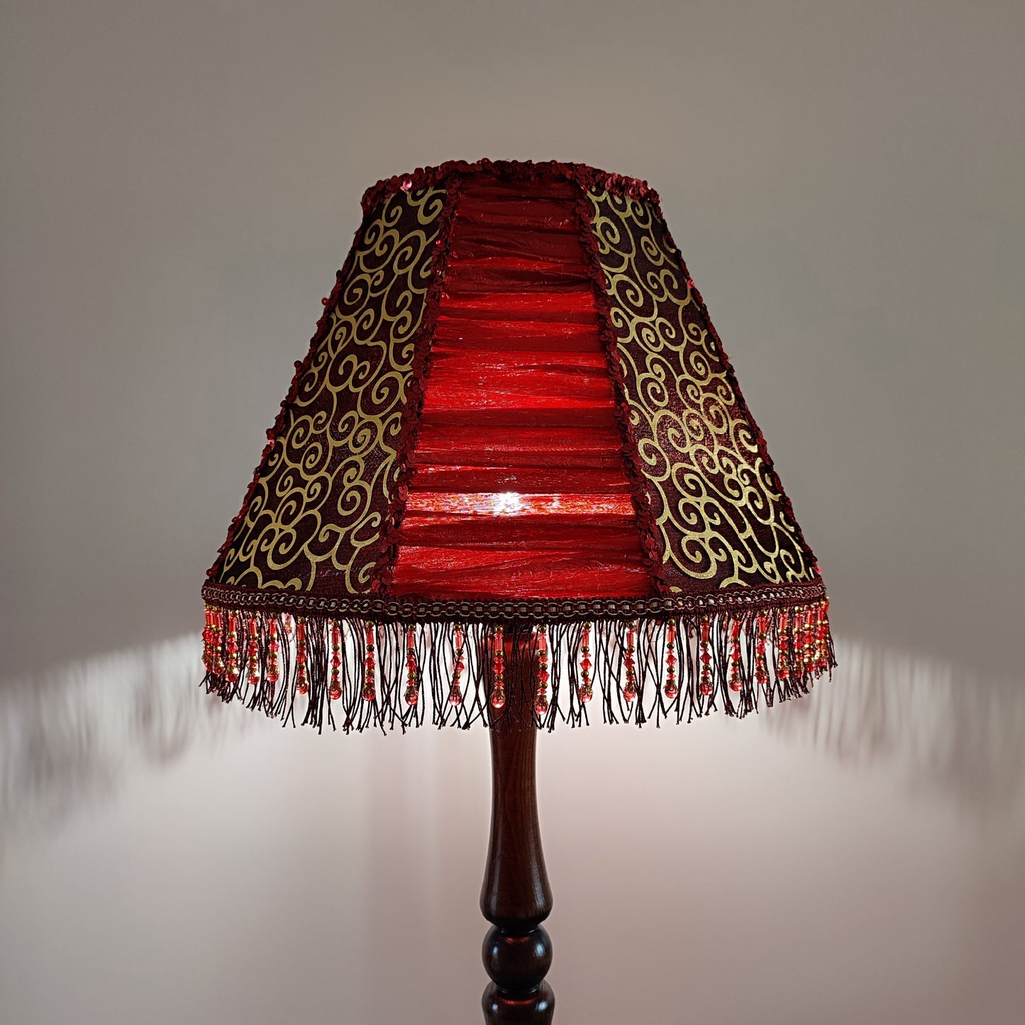 A burgundy lampshade with a swirling pattern and beaded fringe.Unique lamp, handcrafted laтббmp, decorative lamp. 1116